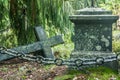 Fallen ÃÂross and chain at old beautiful semetery in Finland